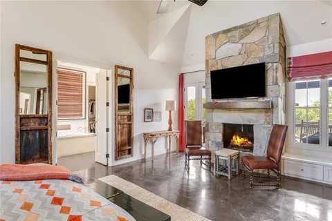 a living room with furniture a flat screen tv and a fireplace