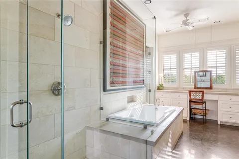 a bathroom with a granite countertop sink a mirror and a bathtub