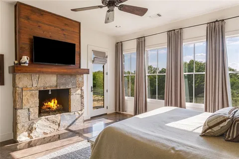 a bedroom with a bed and a fireplace