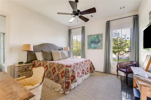 a bedroom with a bed window and chair