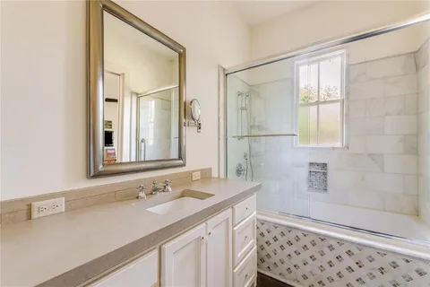 a bathroom with a sink a vanity and a mirror