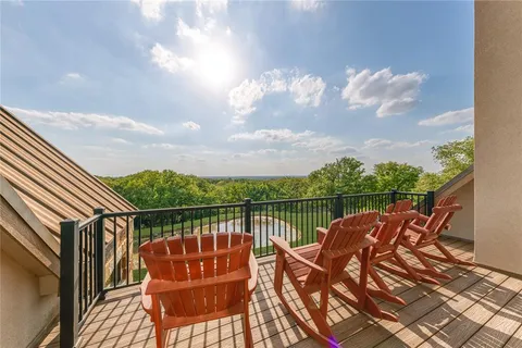 a view of a roof deck with couches and wooden floor