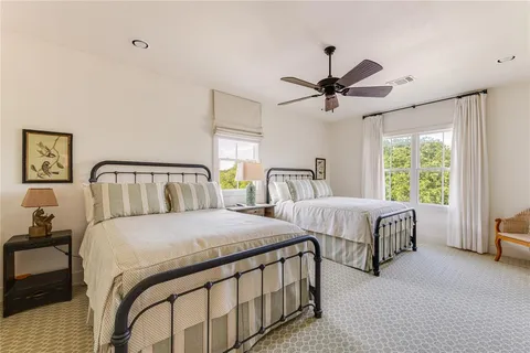 a bedroom with two beds and a chandelier