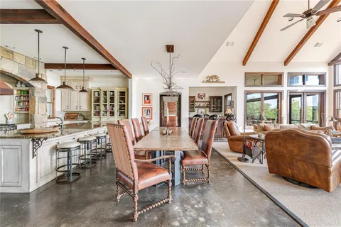 a dining room with furniture and a large window