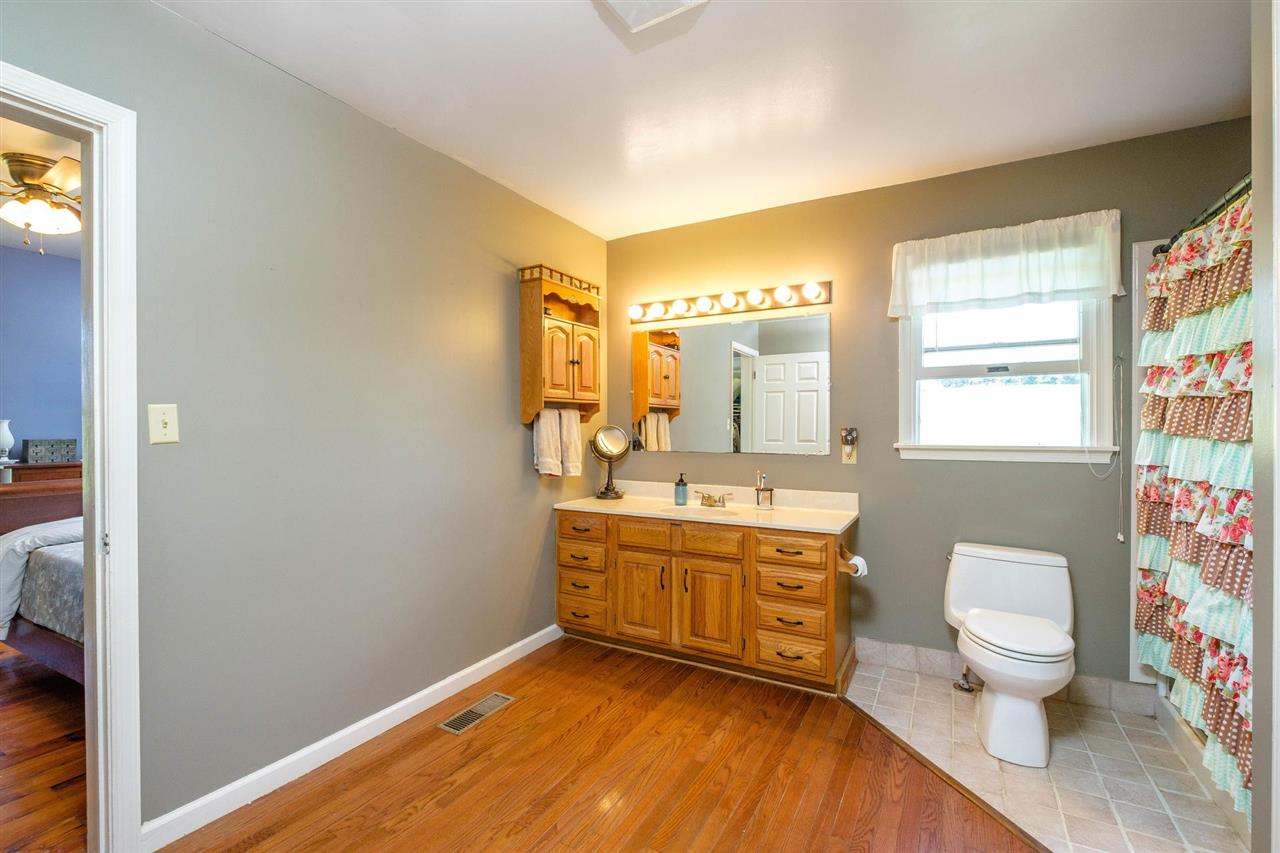 3557 Shutterlee Mill Road Staunton, VA 24401 - Photo 13 of 42 a bathroom with a granite countertop sink mirror vanity and a toilet