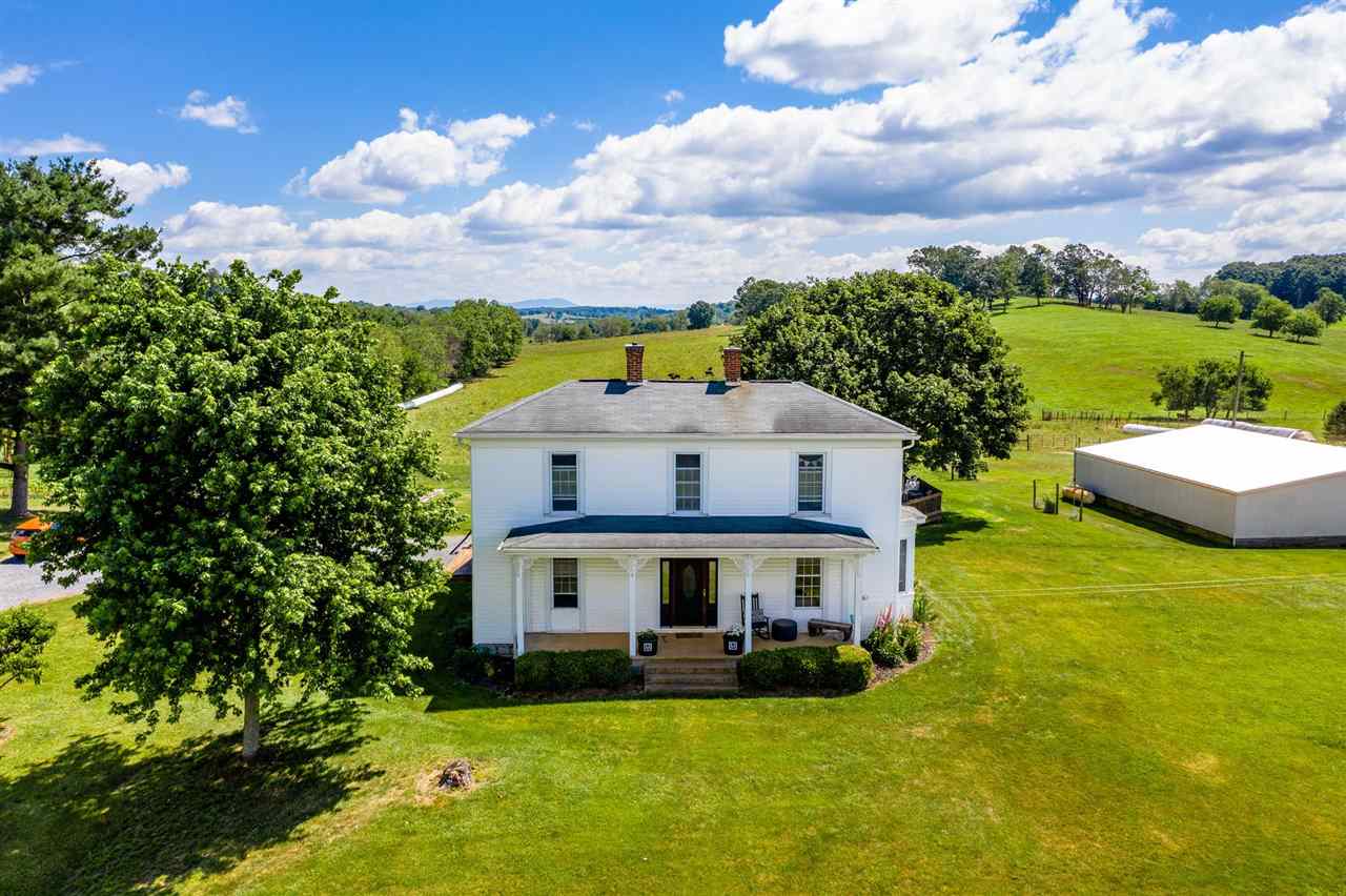 3557 Shutterlee Mill Road Staunton, VA 24401 - Photo 34 of 42 a view of a house with a big yard potted plants and a large tree