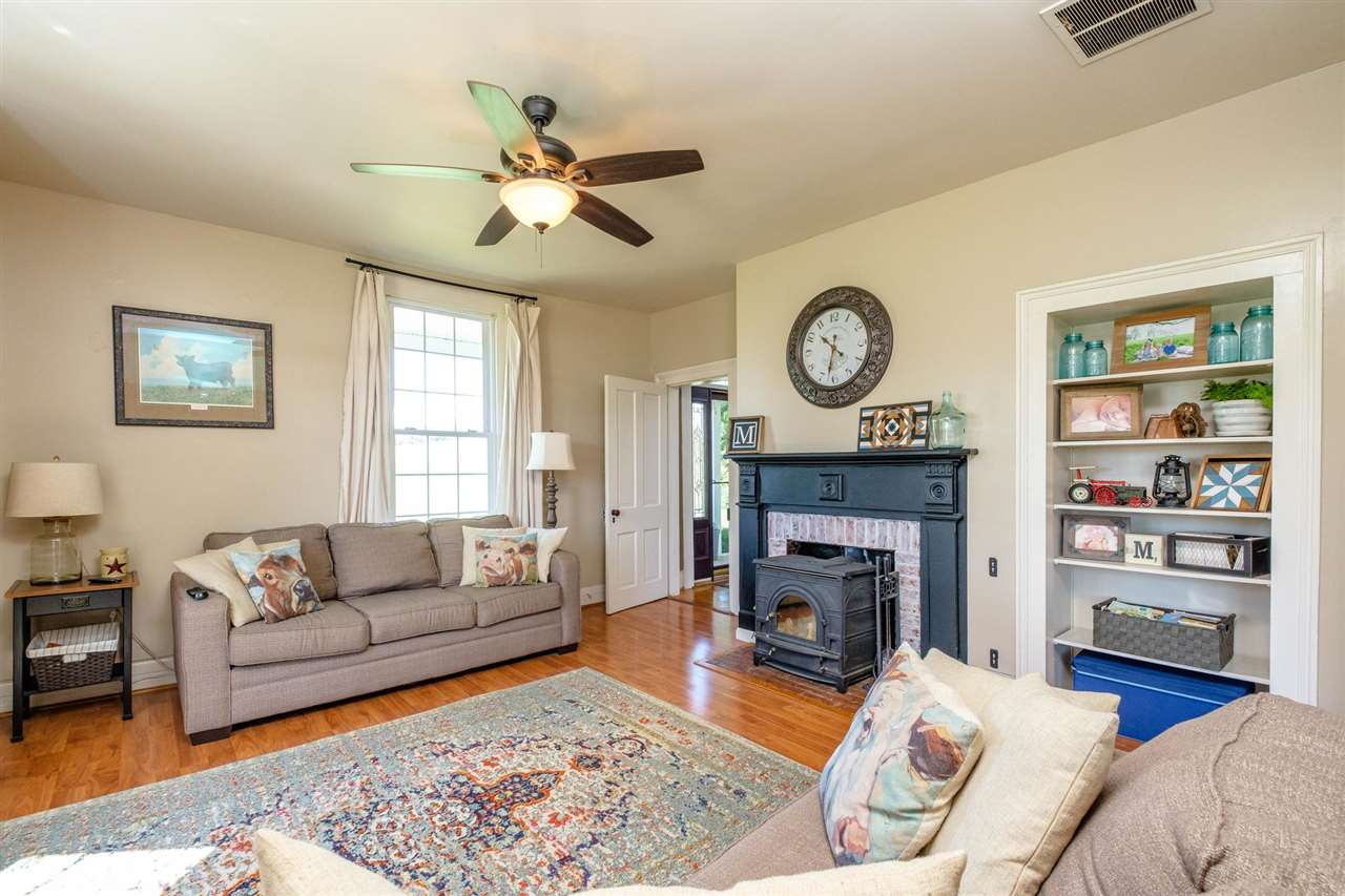 3557 Shutterlee Mill Road Staunton, VA 24401 - Photo 8 of 42 a living room with furniture a fireplace and a window