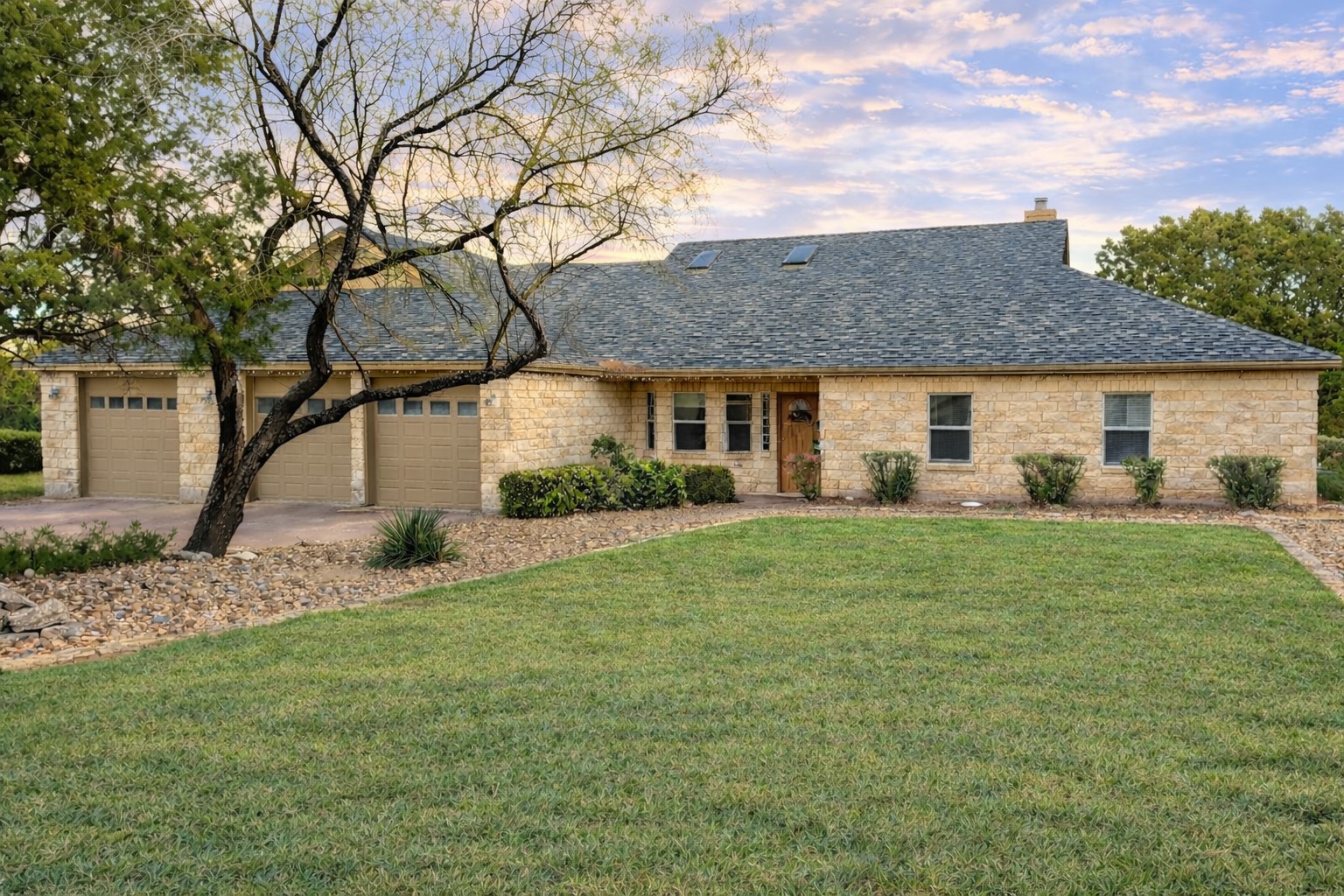 a front view of house with a garden