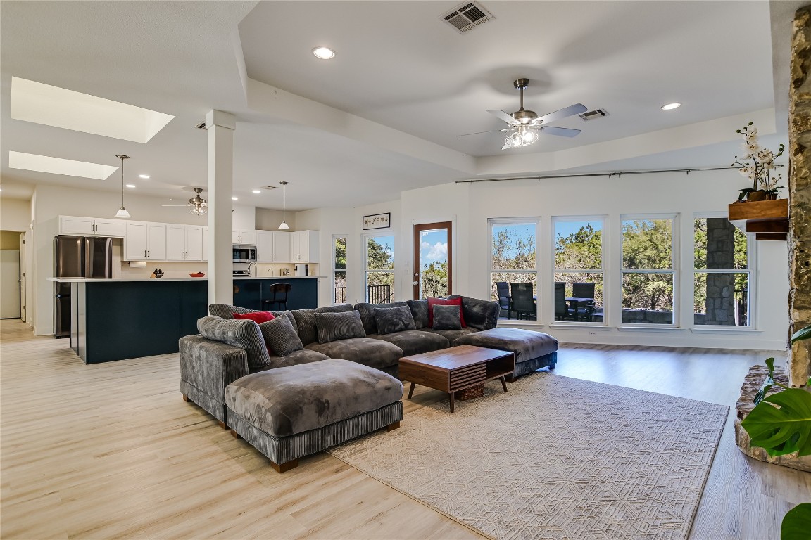 945 Wesley Ridge Drive Spicewood, TX 78669 - Photo 13 of 40 Living area framed by a wall of windows brings the outdoors in and fills the space with natural light throughout the day.