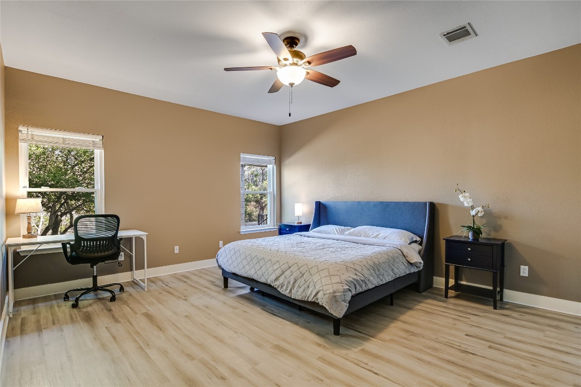 945 Wesley Ridge Drive Spicewood, TX 78669 - Photo 21 of 40 The primary bedroom is located in its own wing of the home, offering separation from the secondary bedrooms.