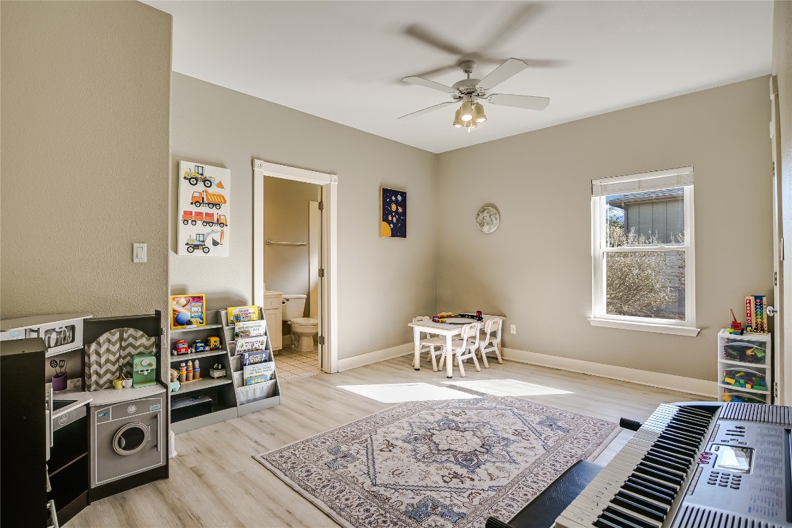 945 Wesley Ridge Drive Spicewood, TX 78669 - Photo 23 of 40 Bedroom with a private ensuite bath, ideal for guests or multi-generational living.