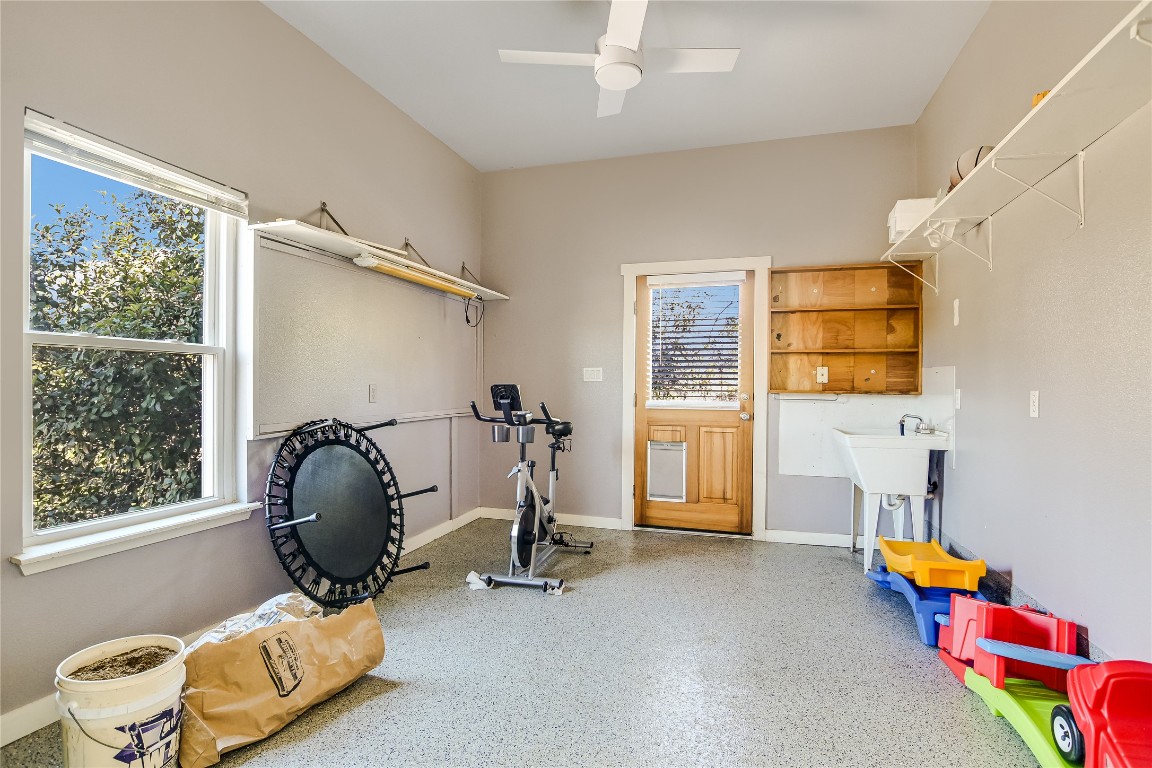 945 Wesley Ridge Drive Spicewood, TX 78669 - Photo 29 of 40 The bonus room is connected to the four-car garage and is heated and cooled, offering flexible use as a workshop, home office, hobby room, or retreat. Includes An EV charging power source for modern convenience.