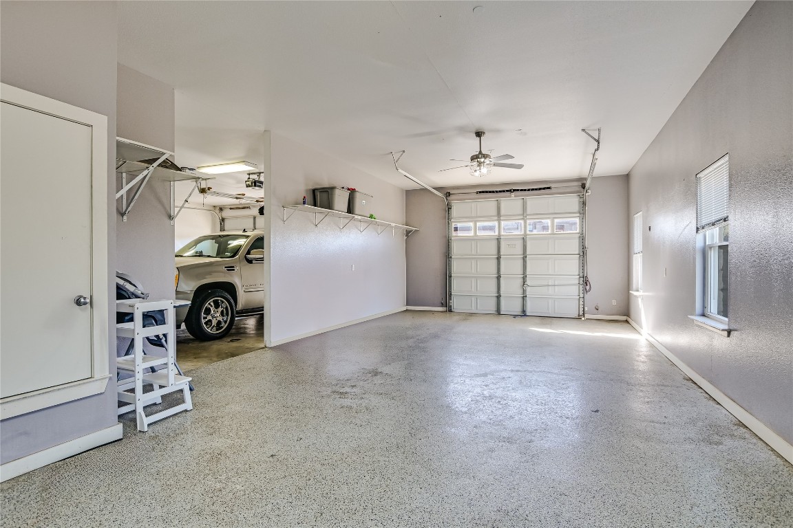 945 Wesley Ridge Drive Spicewood, TX 78669 - Photo 30 of 40 The garage accommodates two vehicles side-by-side in one bay with an additional tandem bay providing two additional spaces.