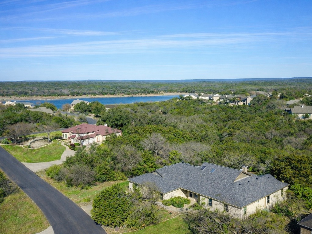 945 Wesley Ridge Drive Spicewood, TX 78669 - Photo 3 of 40 Aerial view highlighting the home’s close proximity to Lake Travis and surrounding Hill Country terrain.