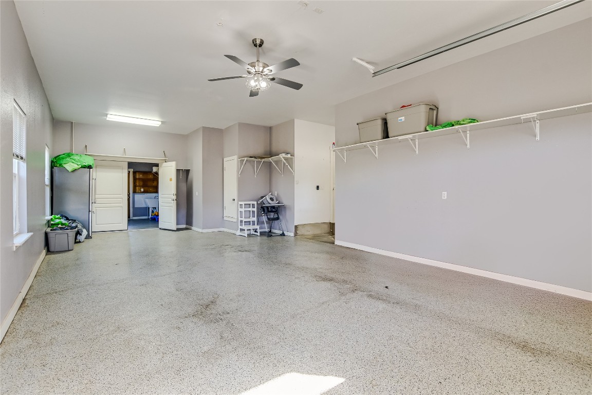 945 Wesley Ridge Drive Spicewood, TX 78669 - Photo 31 of 40 Tandem garage configuration allowing two vehicles in sequence, ideal for additional storage or oversized vehicles.