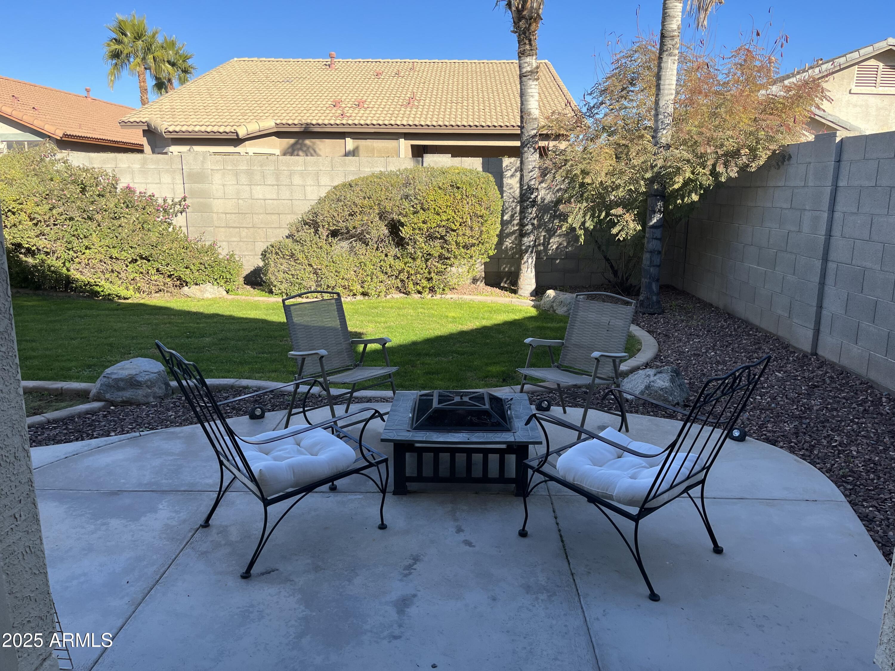 12542 West Honeysuckle Street Litchfield Park, AZ 85340 - Photo 17 of 19 a couple of chairs that are sitting in the backyard