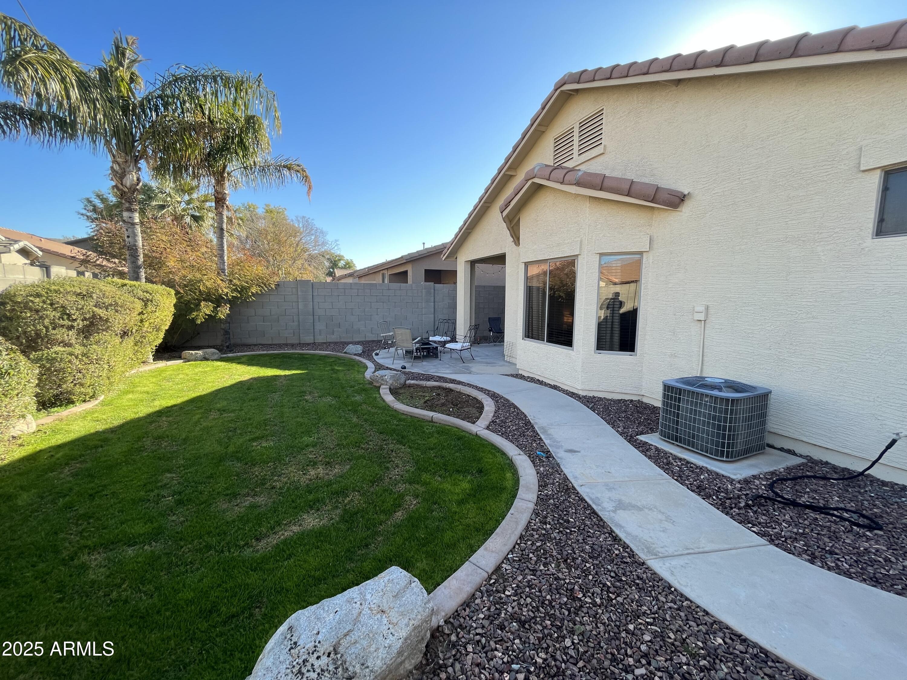 12542 West Honeysuckle Street Litchfield Park, AZ 85340 - Photo 18 of 19 a front view of a house with garden