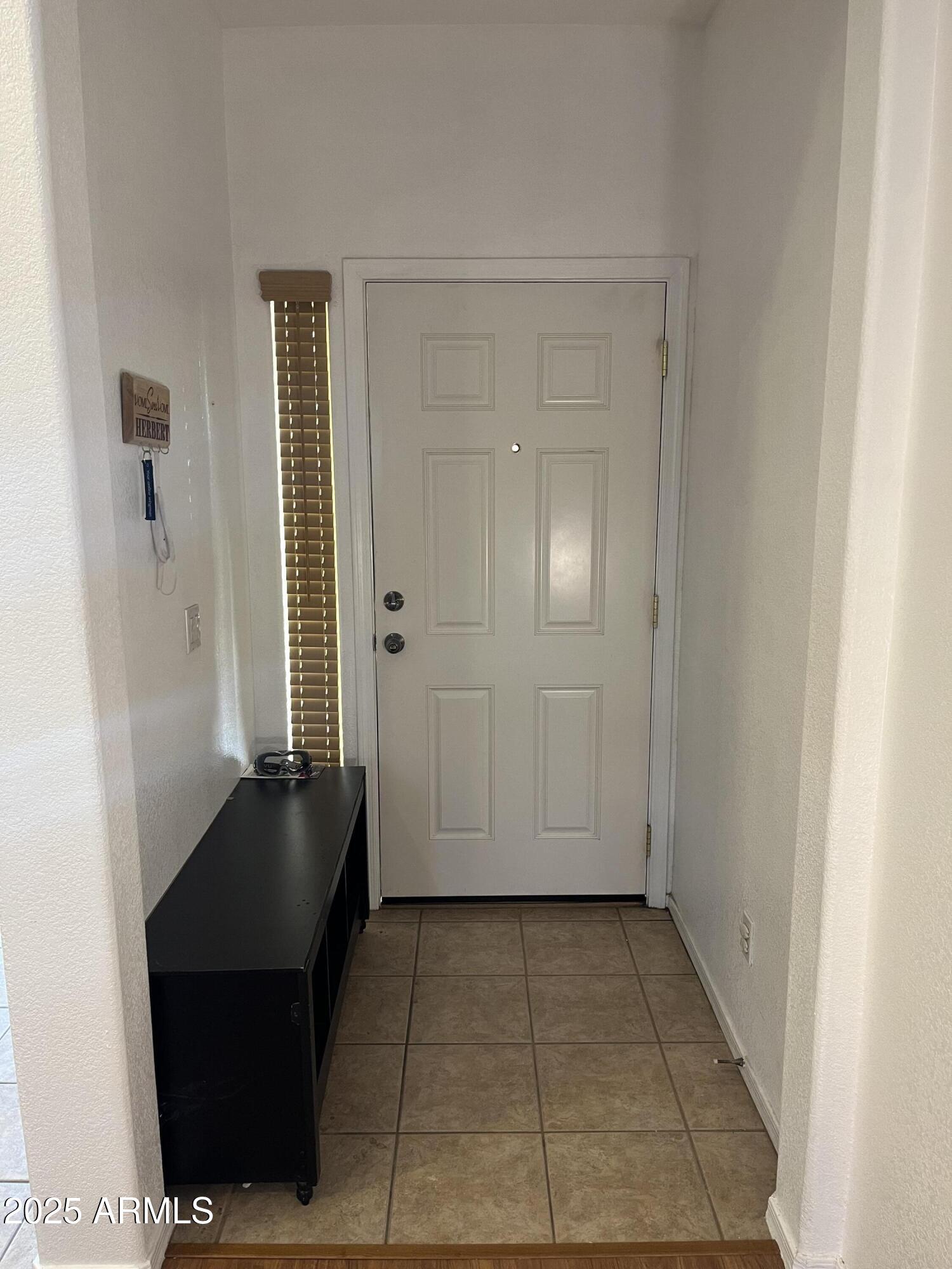 12542 West Honeysuckle Street Litchfield Park, AZ 85340 - Photo 2 of 19 a view of a closet area with living room