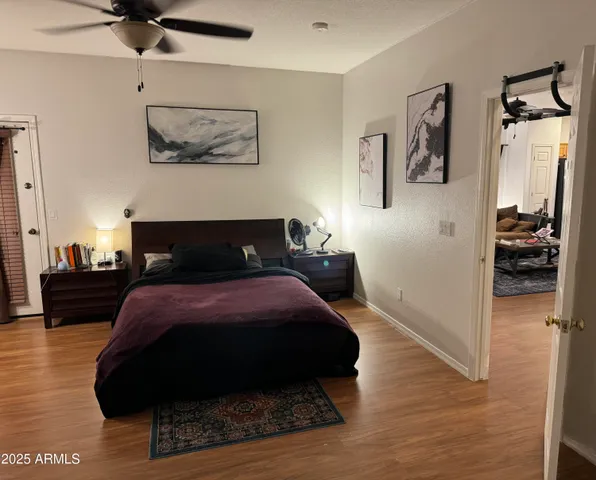 a bedroom with a bed and wooden floor