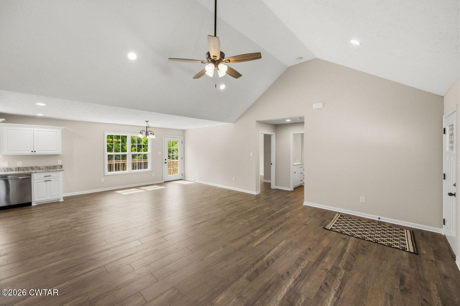 435 Old Huntingdon Road Lexington, TN 38351 - Photo 4 of 26 an empty room with wooden floor chandelier and windows