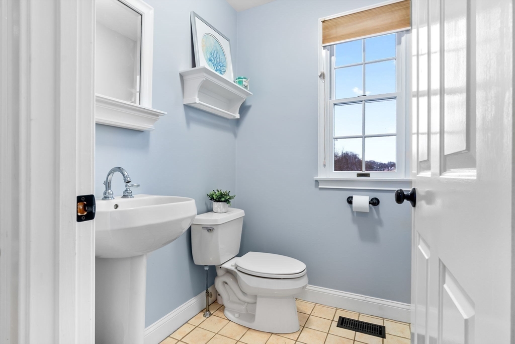 253 High Road Newbury, MA 01951 - Photo 19 of 42 a bathroom with a sink a toilet and a window