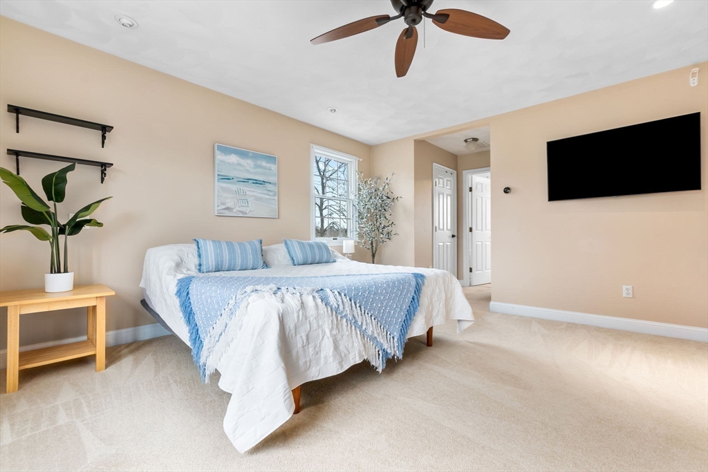 253 High Road Newbury, MA 01951 - Photo 21 of 42 a spacious bedroom with a bed and a flat screen tv