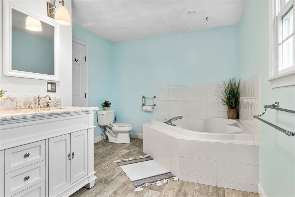 253 High Road Newbury, MA 01951 - Photo 24 of 42 a spacious bathroom with a granite countertop sink a toilet and bathtub