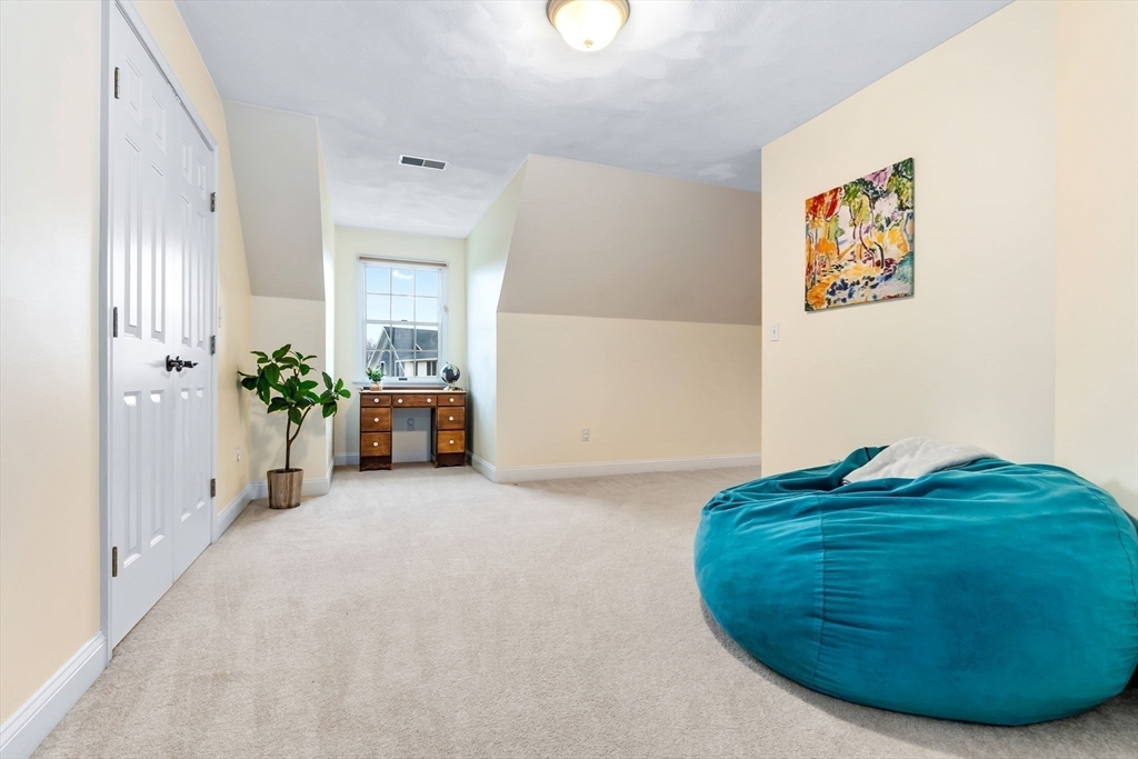 253 High Road Newbury, MA 01951 - Photo 27 of 42 a view of a hallway with two chairs and a potted plant