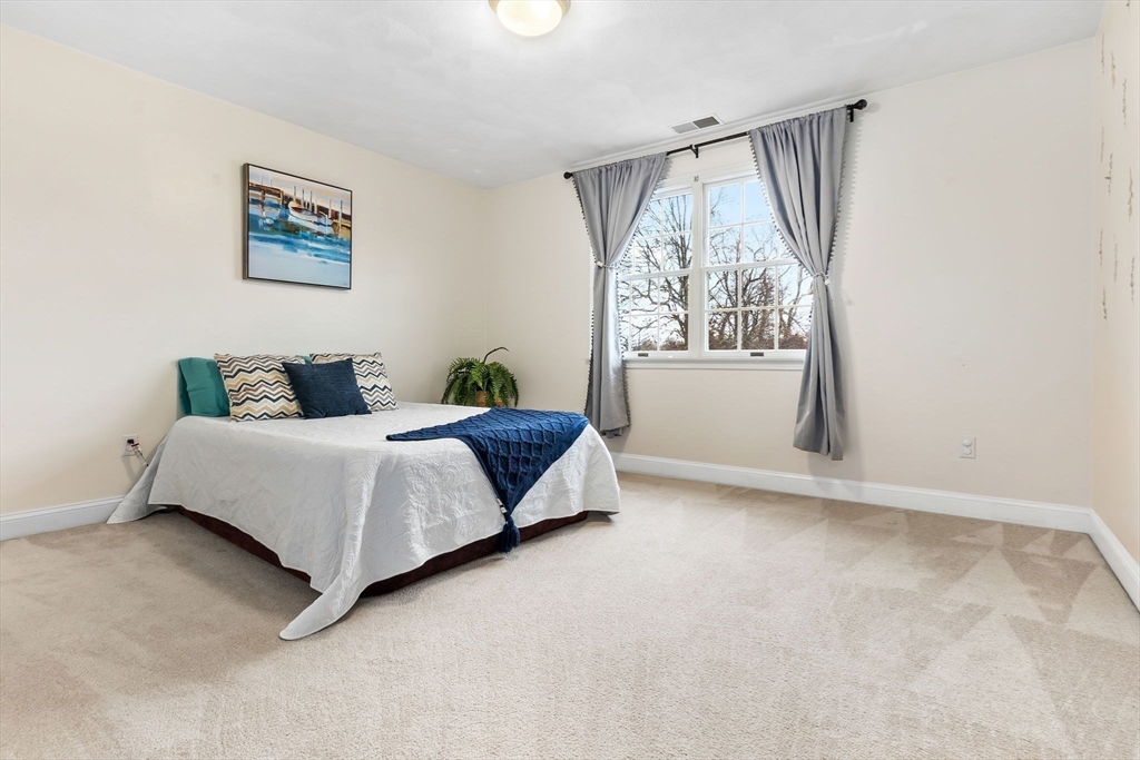 253 High Road Newbury, MA 01951 - Photo 28 of 42 a bedroom with a bed and a window