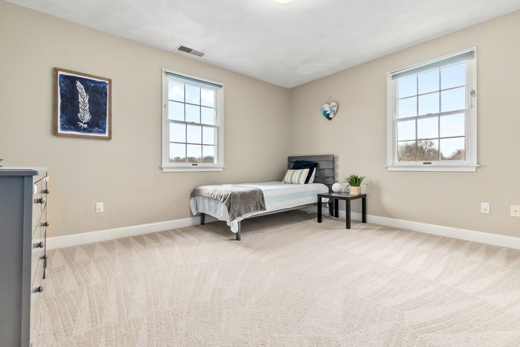 253 High Road Newbury, MA 01951 - Photo 29 of 42 a spacious bedroom with a bed and a window