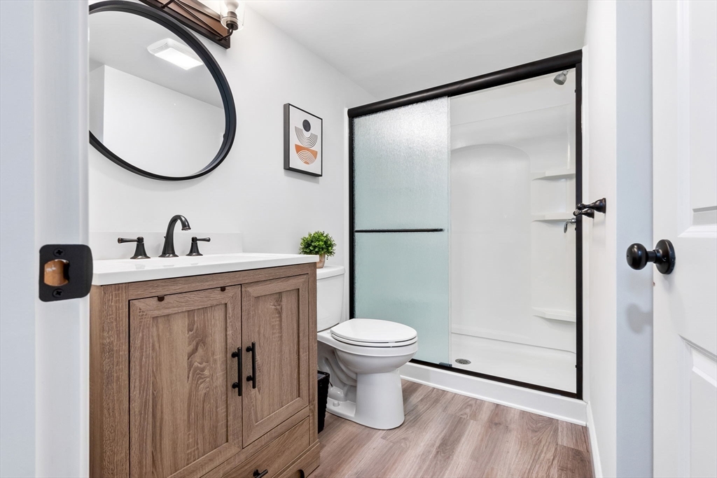253 High Road Newbury, MA 01951 - Photo 33 of 42 a bathroom with a toilet sink and mirror