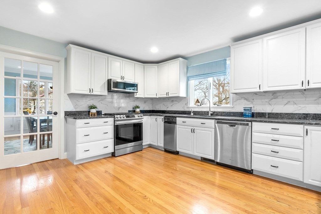 253 High Road Newbury, MA 01951 - Photo 5 of 42 a kitchen with granite countertop white cabinets and stainless steel appliances
