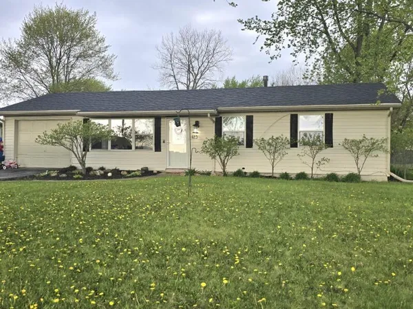 a view of a house with a backyard and a garden