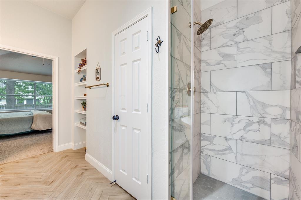 7306 Vista Ridge Lane Sachse, TX 75048 - Photo 16 of 23 a view of walk in closet with window and bathroom