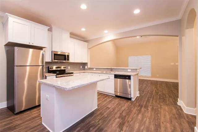 a kitchen with stainless steel appliances a refrigerator stove and sink