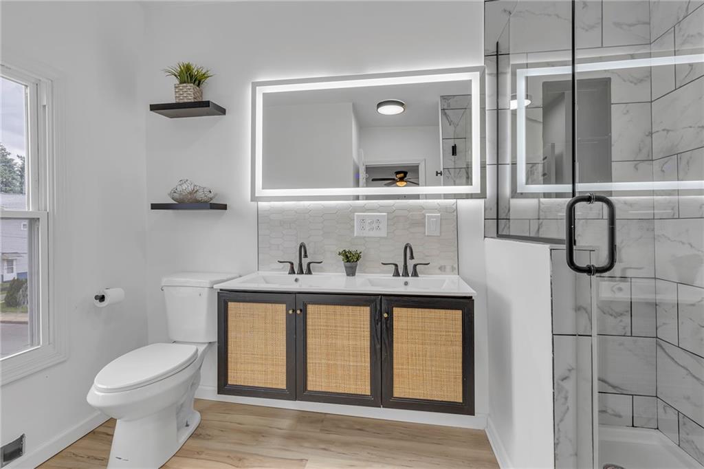 193 Virginia Avenue Rochester, PA 15074 - Photo 22 of 37 a bathroom with a toilet a sink and mirror