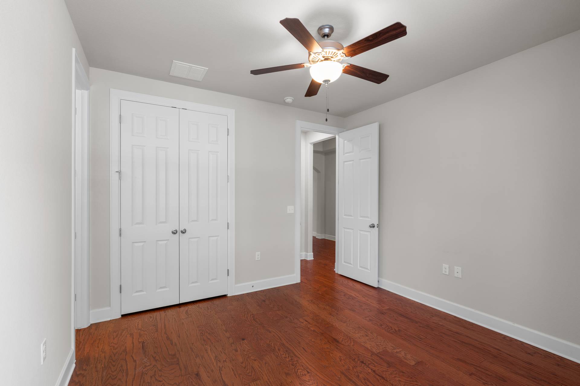 3516 Venezia View Leander, TX 78641 - Photo 14 of 40 Unfurnished bedroom featuring a ceiling fan, dark wood finished floors, and a closet