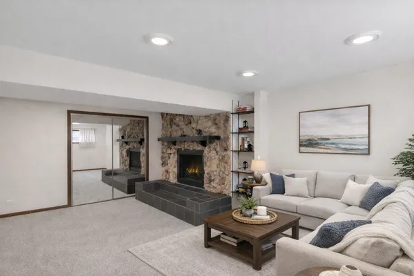 a living room with furniture and a fireplace