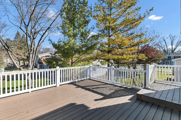 a view of balcony with wooden floor and fence