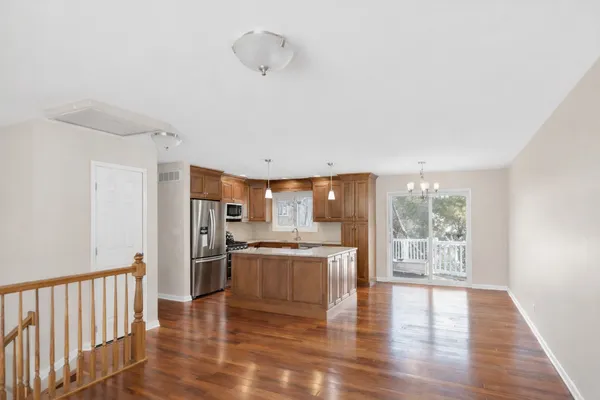 a view of a kitchen with wooden floor and a window