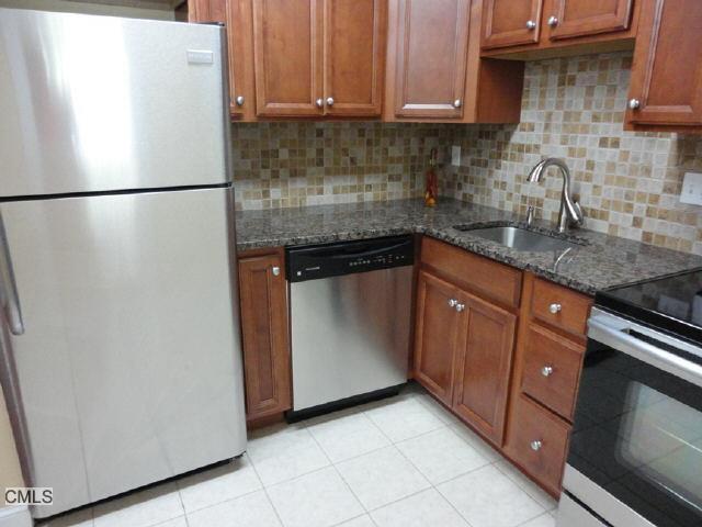 114 Balance Rock Road, Unit 18 Seymour, CT 06483 - Photo 1 of 1 a white refrigerator freezer sitting inside of a kitchen