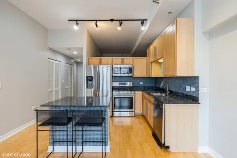 a kitchen with stainless steel appliances granite countertop a stove and a refrigerator