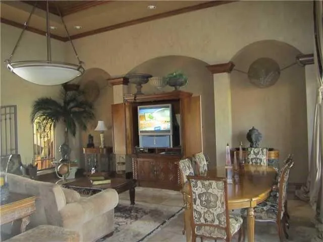 a dining room with furniture and a chandelier