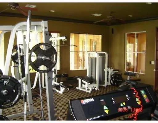 a room with lots of potted plants and wooden floor