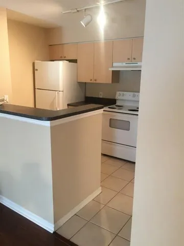 a kitchen with a sink a stove and cabinets