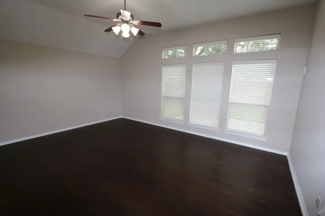 a view of wooden floor and windows in a room