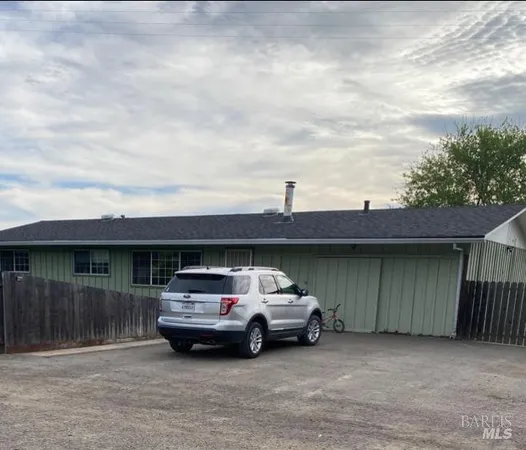 a view of a car parked in front of a house