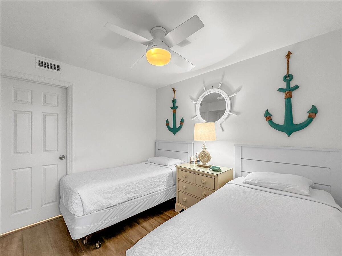 1002 Highway 98, Unit 316 Destin, FL 32541 - Photo 15 of 31 a bedroom with a bed and dresser