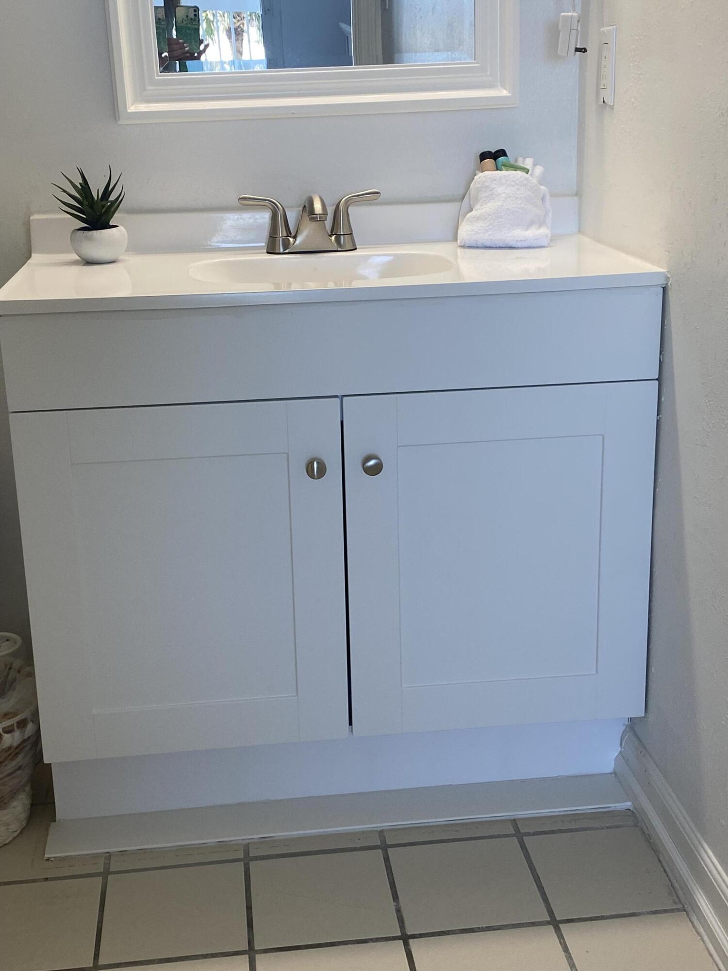 1002 Highway 98, Unit 316 Destin, FL 32541 - Photo 31 of 31 a bathroom with a sink and a mirror