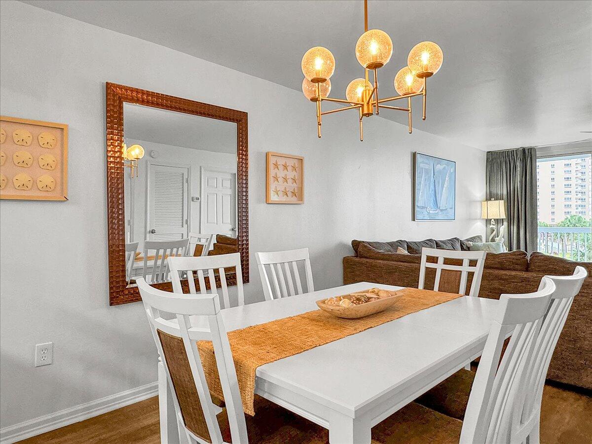 1002 Highway 98, Unit 316 Destin, FL 32541 - Photo 9 of 31 a view of a dining room with a table and chairs